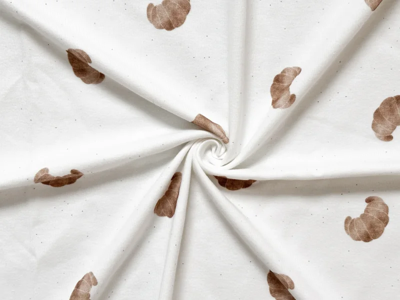 Baumwolljersey Croissant Off White – Restmeter | Jersey Stoff mit handgezeichneten Croissants